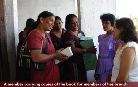 A member carrying copies of the book for the members of her branch