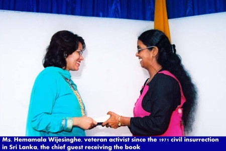 Ms Hemamala Wijesinghe, veteran activist since the 1971 civial insurrection in Sri Lanka, the chief guest receiving the book.