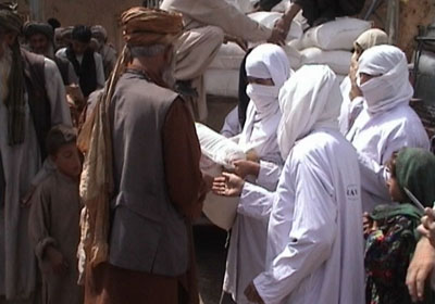 RAWA members distribute flour to refugees