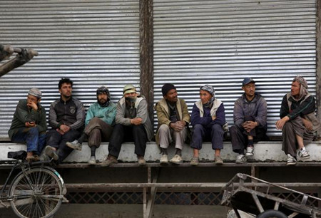 Afghan labor workers wait for customers in Kabul, Afghanistan
