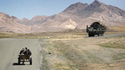 A cart and Stryker armored personnel carrier near Shah-Wali-Kot